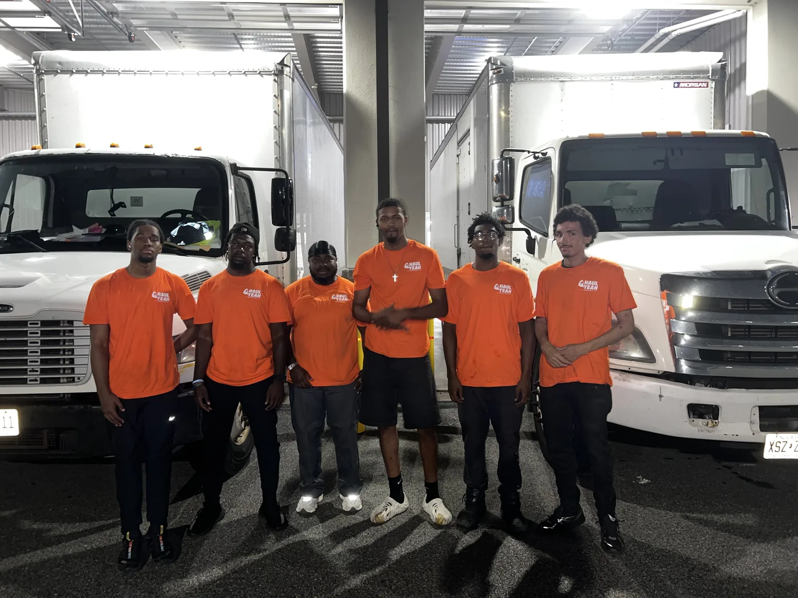 The Haul Yeah Moving crew standing with the box-truck fleet in Essex County, NJ